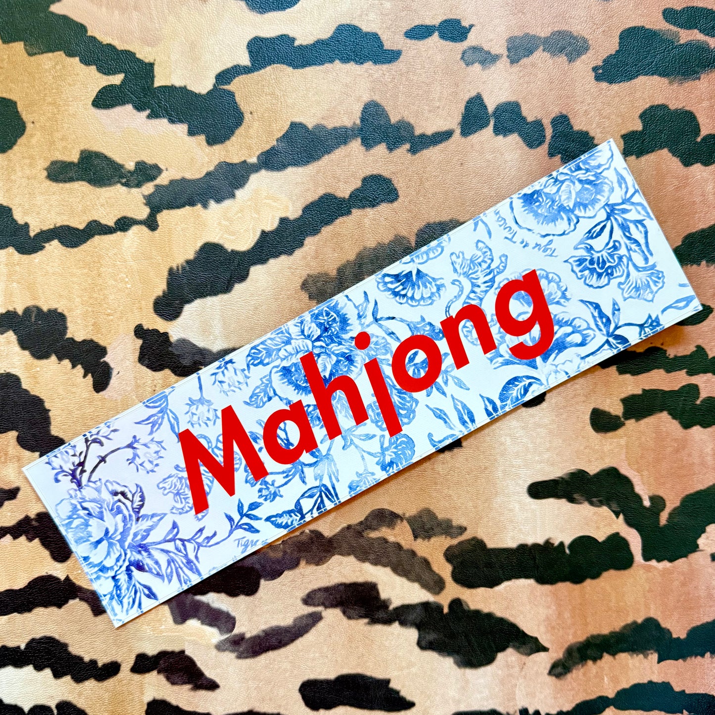 Mahjong bumper sticker, blue-and-white floral with red lettering
