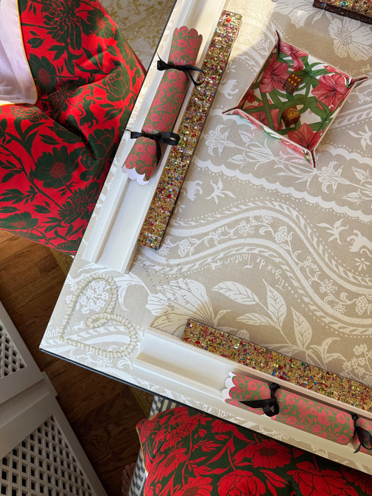 Corner of the Domino Blonde mat with a beaded rack, a pink scalloped pusher and a red floral snap tray