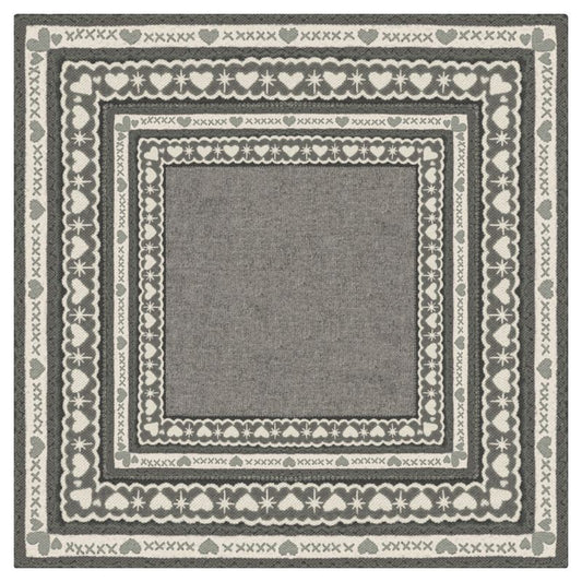 Design render of the Fair Isle Cashmere mahjong mat: a soft grey center framed by knit-style borders of hearts, crosses and scallops in cream and charcoal