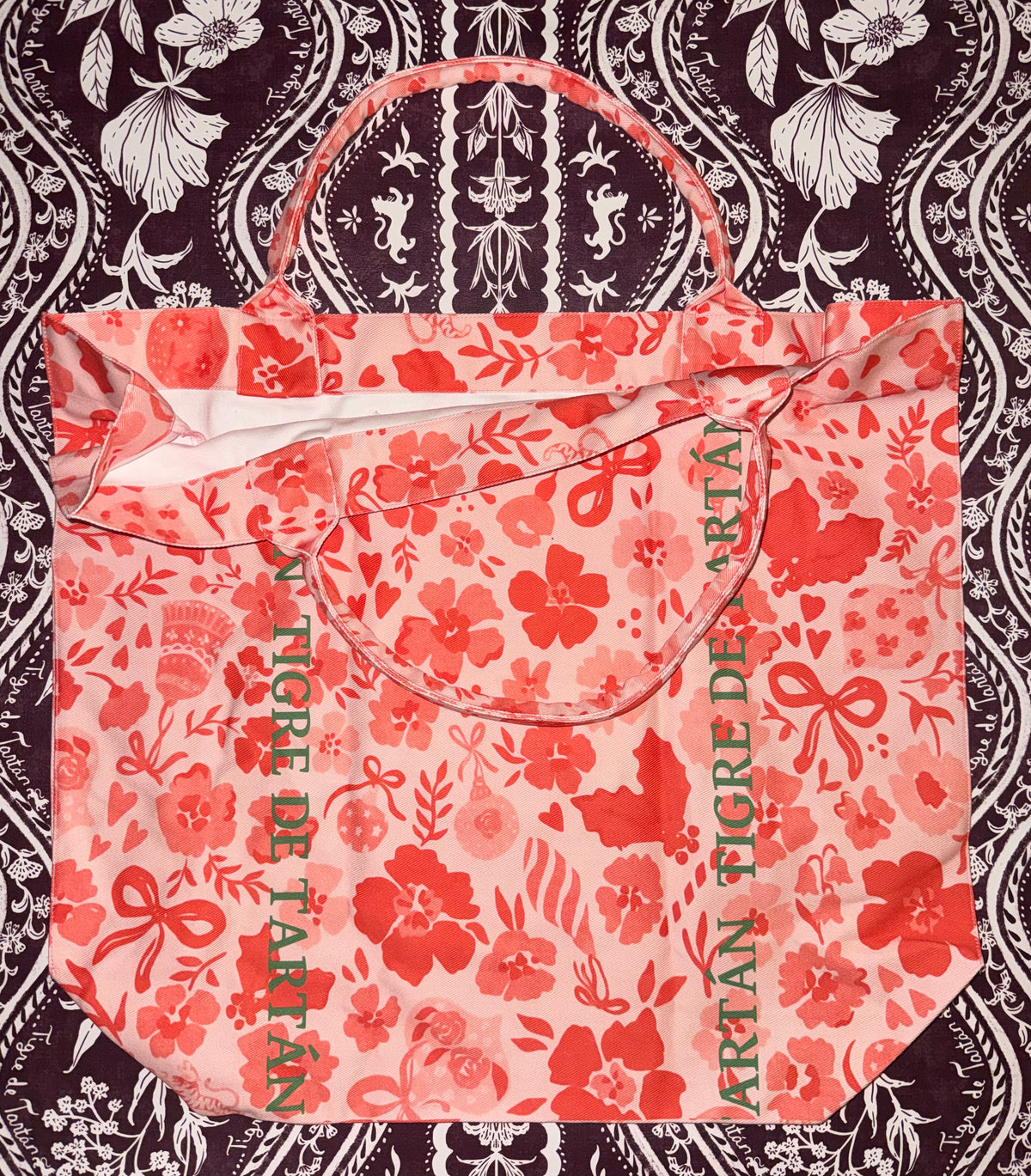 Jumbo slouchy denim tote in the Ditsy Christmas MARASCHINO print with Tigre de Tartán logo lettering, laid flat