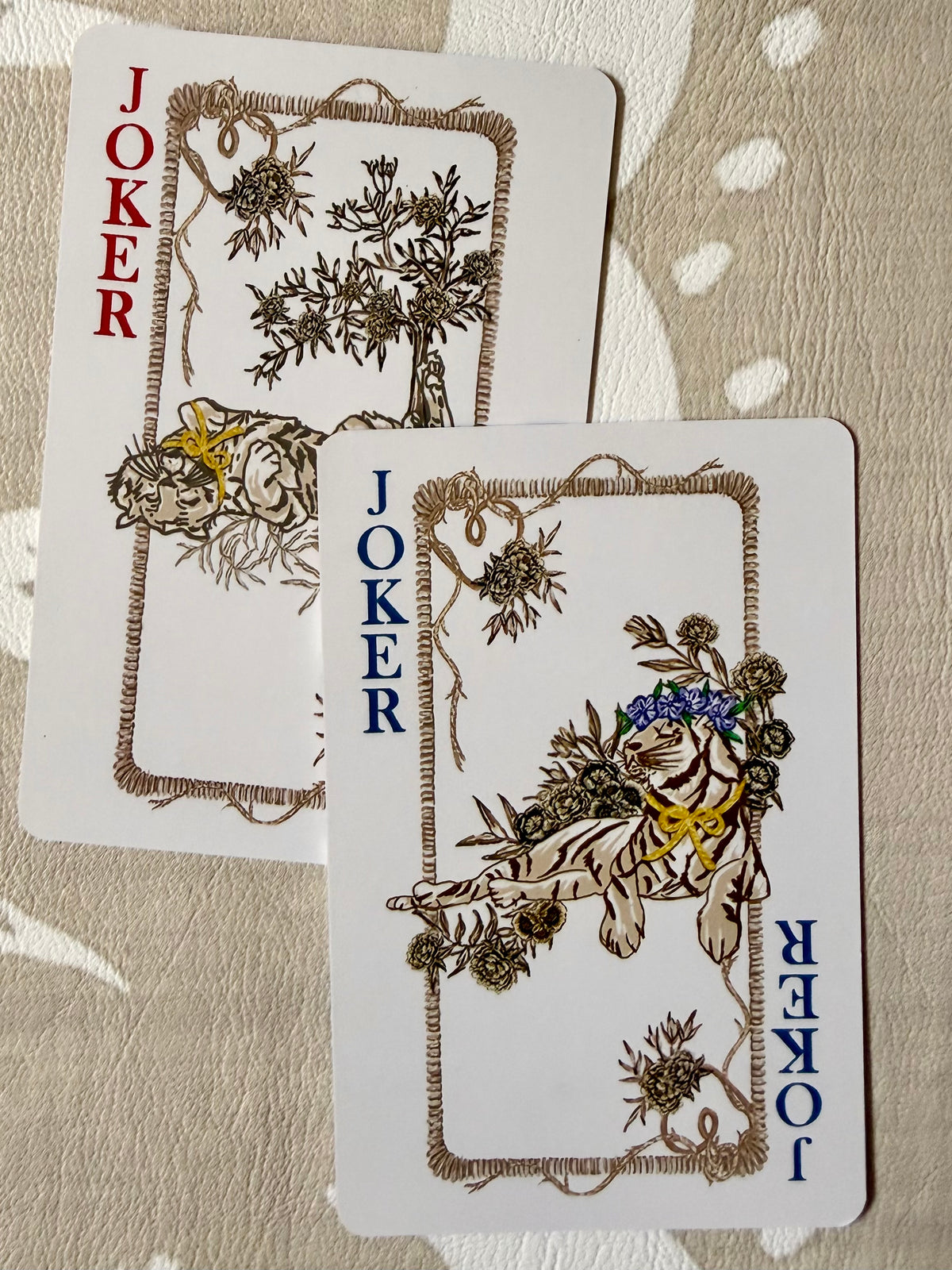 Two joker cards from the Jardín de Los Jefes deck, each with an illustrated tiger among botanicals