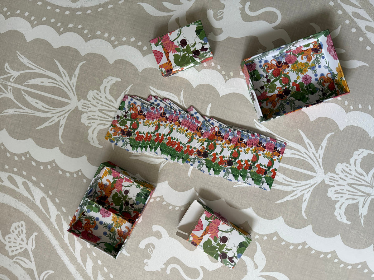Jardín de Los Jefes playing card set unboxed: floral gift box lid and base with two tiger-print card decks
