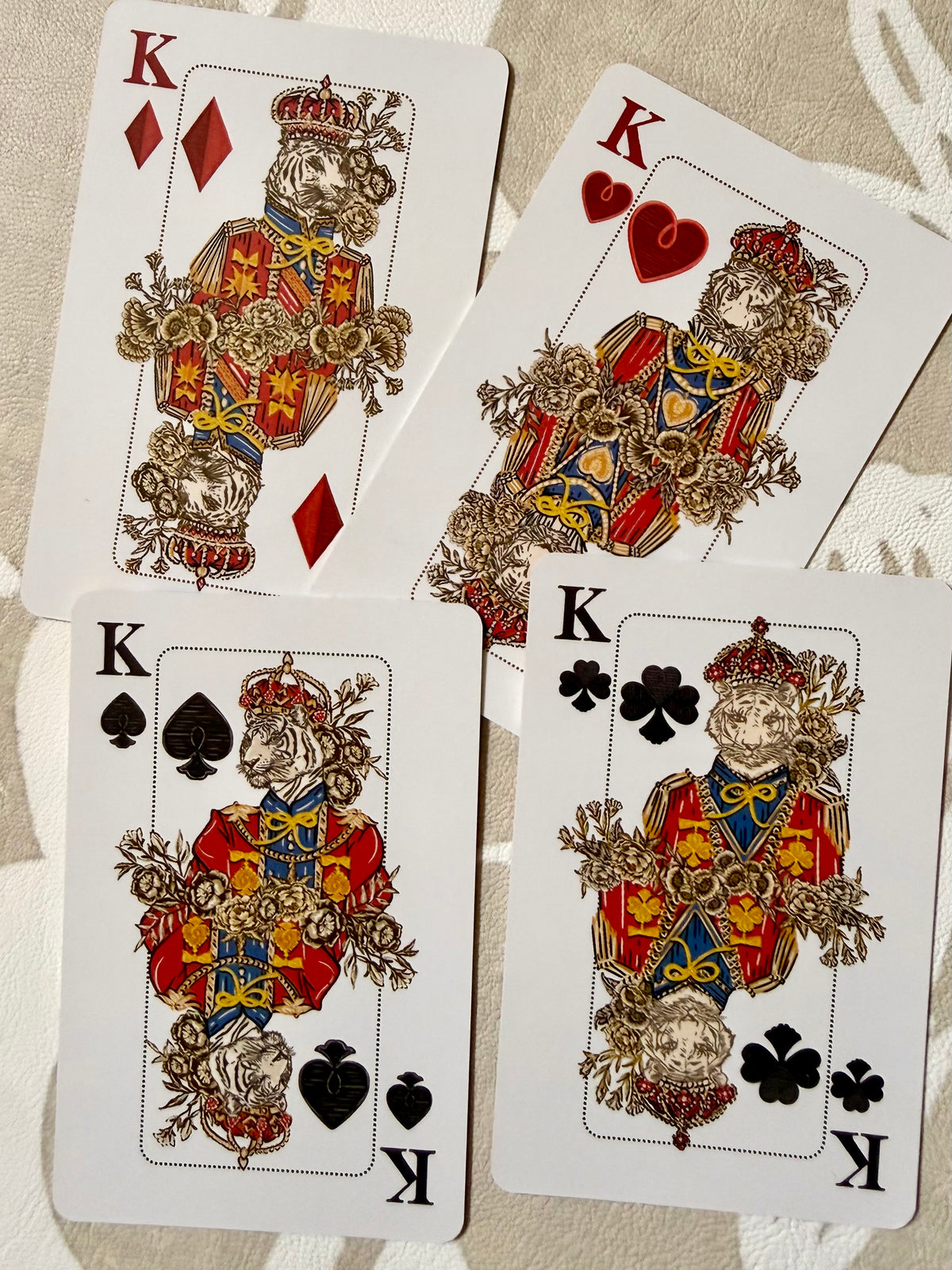Four custom king court cards from the Jardín de Los Jefes playing cards, with big cat and botanical illustration
