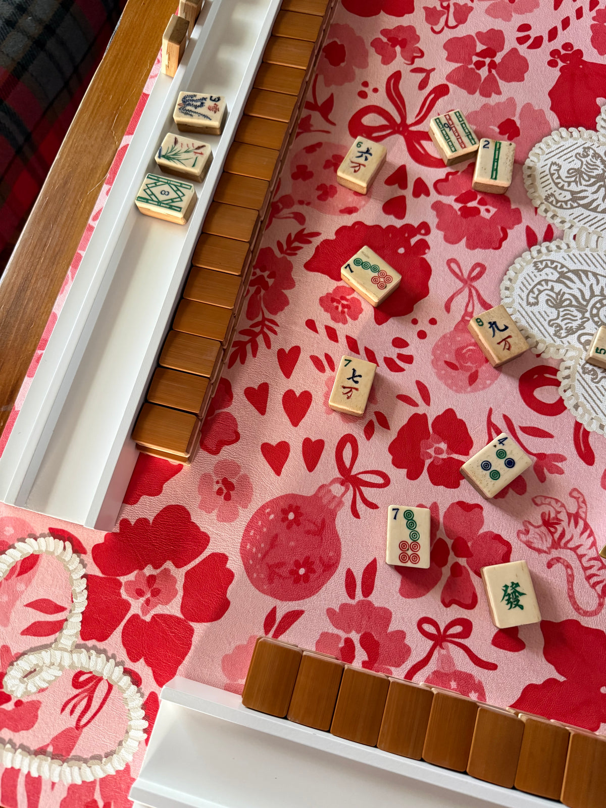 Close-up of tiles and racks on the MARASCHINO mat showing ornament, bow and floral motifs