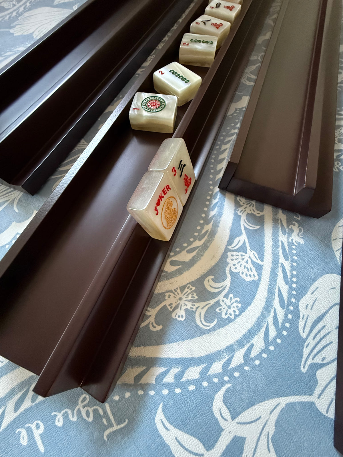 Rich raisin racks holding cream tiles on a blue and white print mat