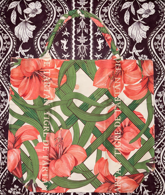 Jumbo slouchy denim tote in the Estate Sale print, coral amaryllis on a green trellis with Tigre de Tartán lettering, on black-and-white damask