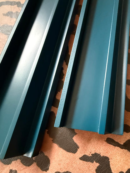 Close-up of two marine blue racks showing the straight pusher edge