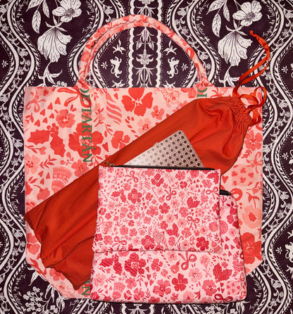 Tote bag and zip pouch in a matching red and pink Ditsy Christmas print on a dark floral background