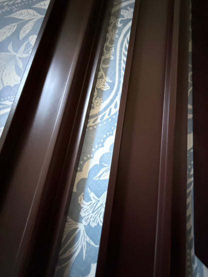 Close-up of two dark raisin racks showing the straight pusher edge
