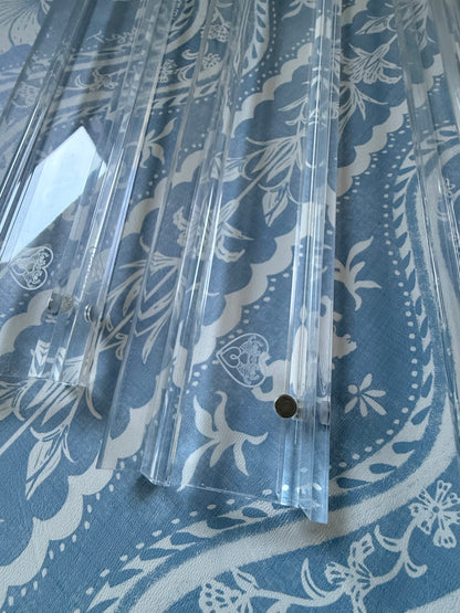 Close-up of clear acrylic racks showing the etched heart logo and magnet points