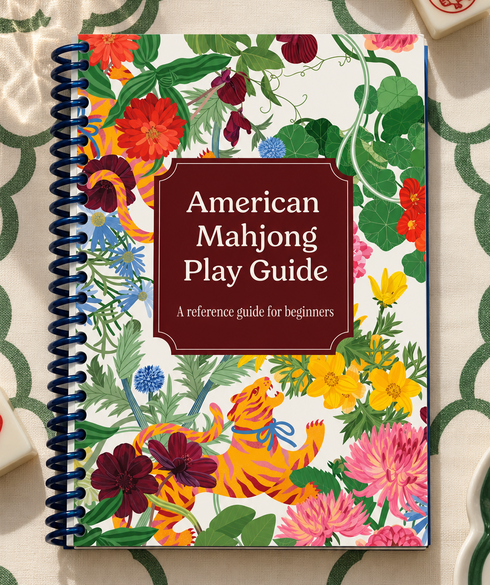 Cover of the spiral-bound American Mahjong Play Guide, English edition, with tigers among bright red, pink and yellow flowers