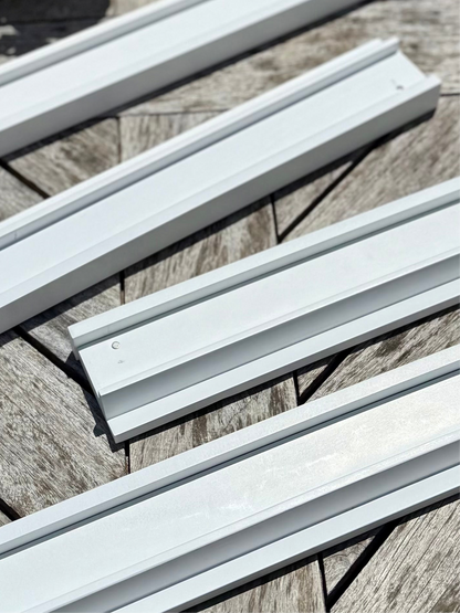 Close-up of white painted beech wood racks showing the tile ledge and visible hardware points