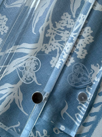Close-up of the etched heart logo and magnet hole on a clear acrylic rack