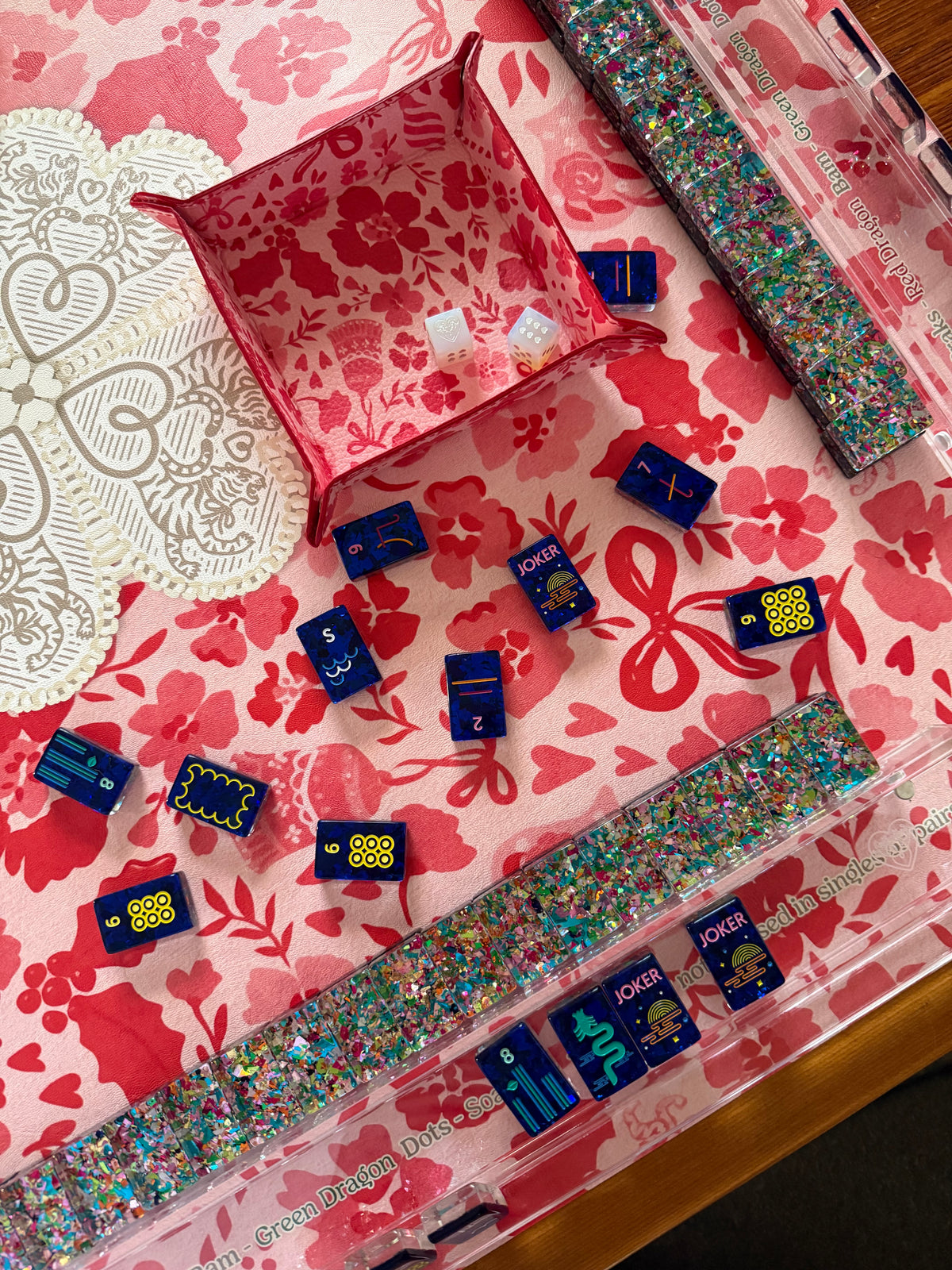 Navy mahjong tiles, glitter acrylic racks and a pink print dice tray on the MARASCHINO mat