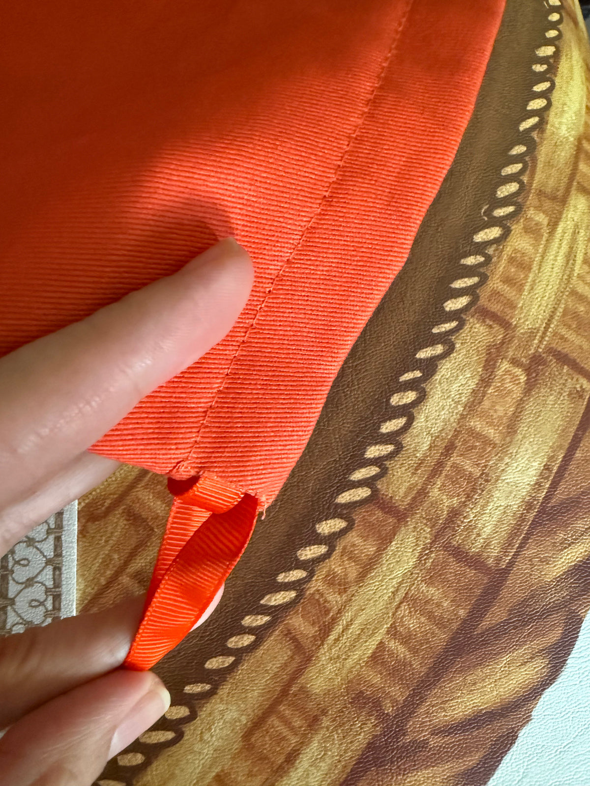 Close-up of the red twill storage bag fabric and its drawstring tab