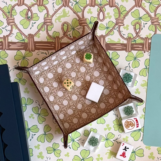 Cannage Blonde caned trompe l'oeil leather snap tray, snapped into shape and holding dice and mahjong tiles