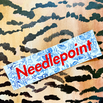 Needlepoint bumper sticker, blue-and-white floral with red lettering