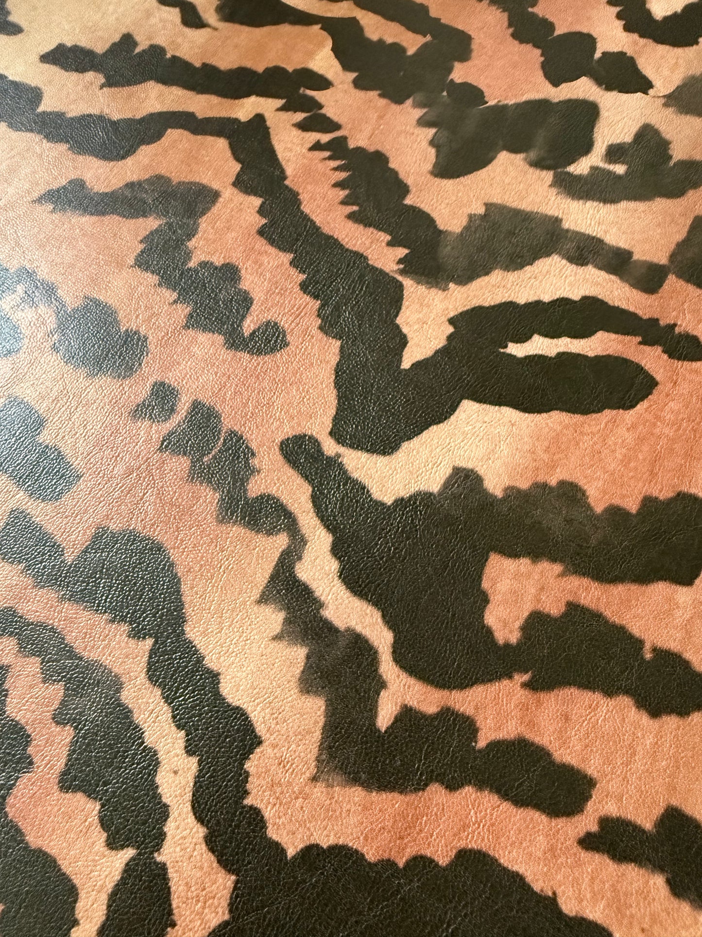Close-up of the El Tigre watercolor tiger stripe print on PLAYFINISH faux leather