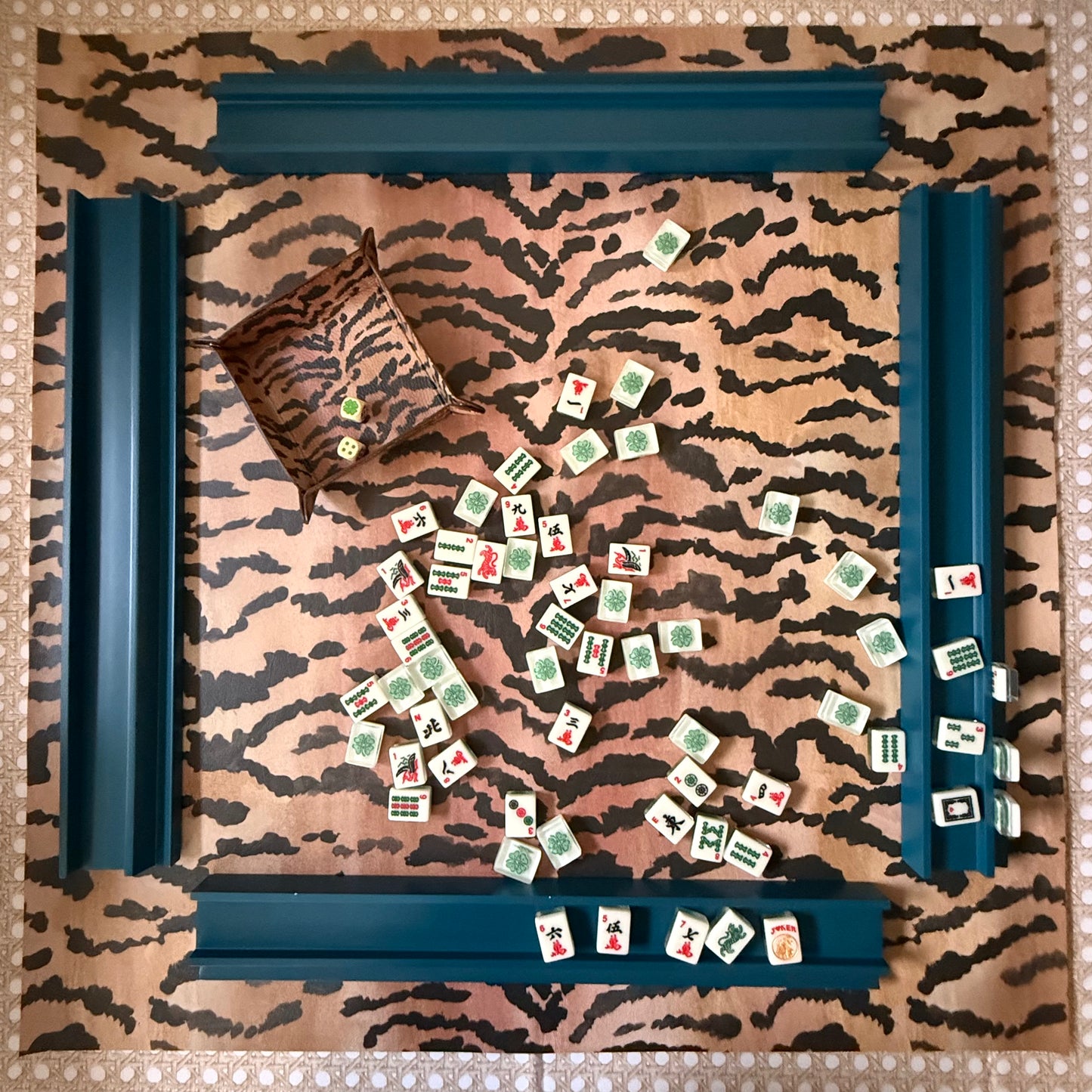Overhead view of the full 31.5-inch El Tigre mahjong mat set with four navy racks and mahjong tiles