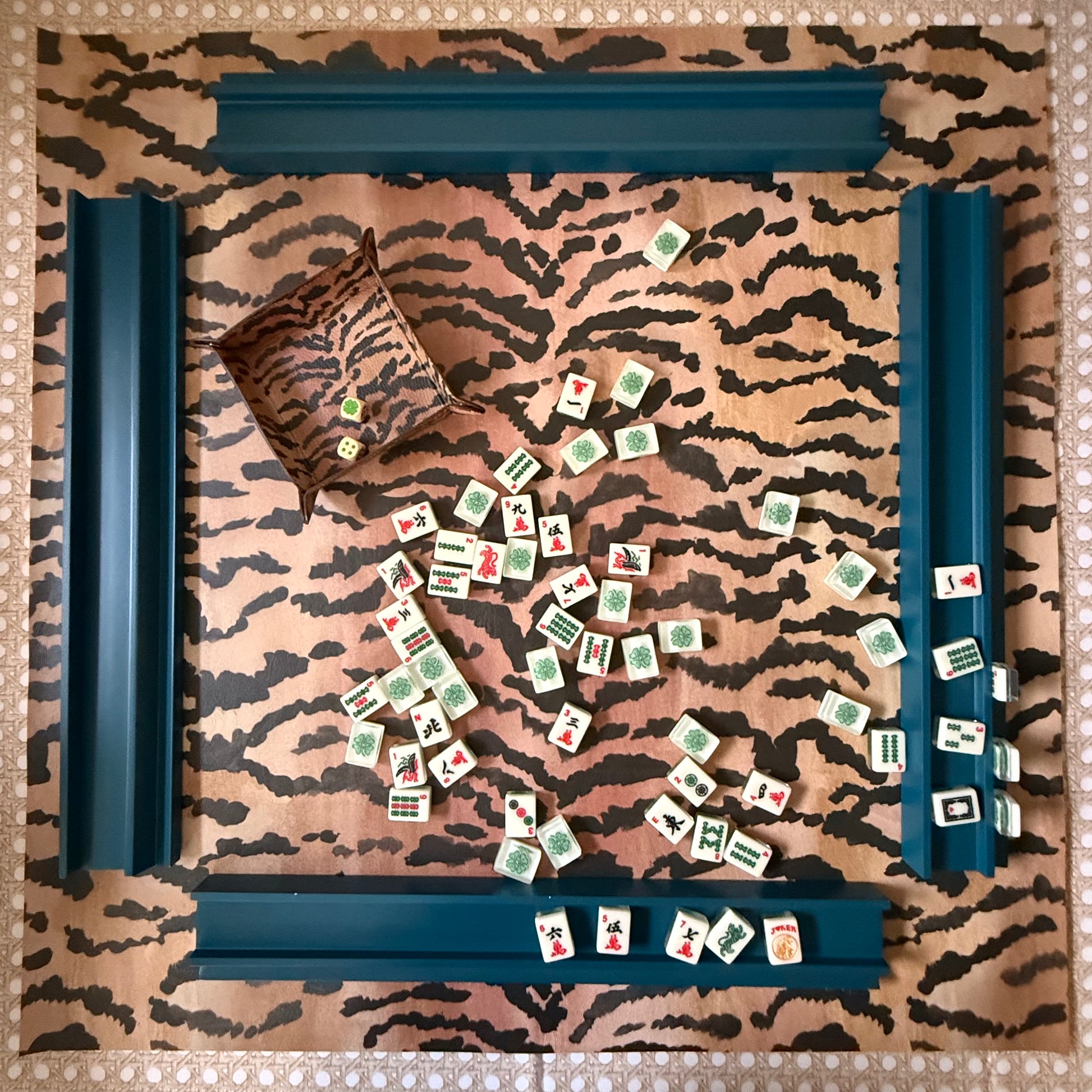 Overhead view of the full 31.5-inch El Tigre mahjong mat set with four navy racks and mahjong tiles