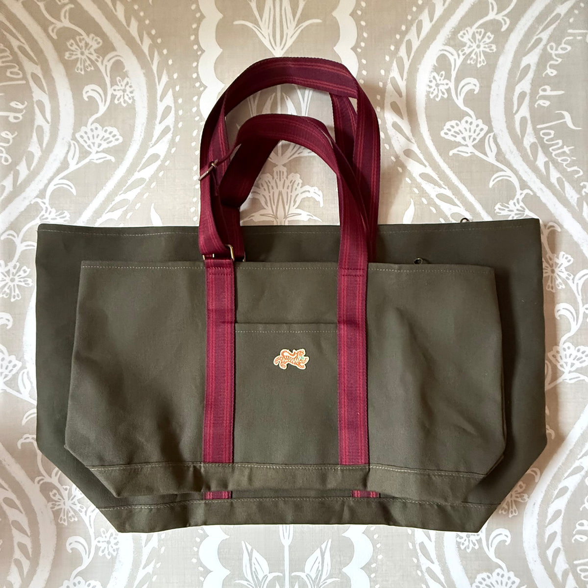 Olive Signature XL Canvas Tote with a smaller olive canvas tote in front to show scale
