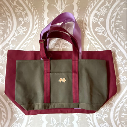 Oxblood Signature XL Canvas Tote with a smaller olive canvas tote laid on top to show scale