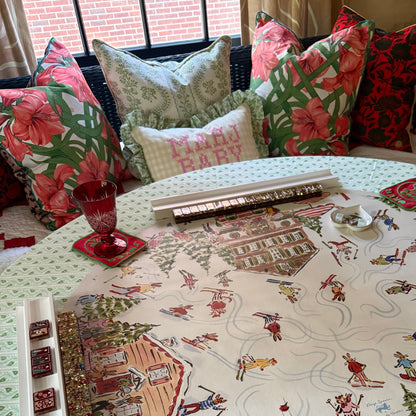 Estate Sale and floral pillows piled on a window seat beside a mahjong table set with the Après Mahj mat