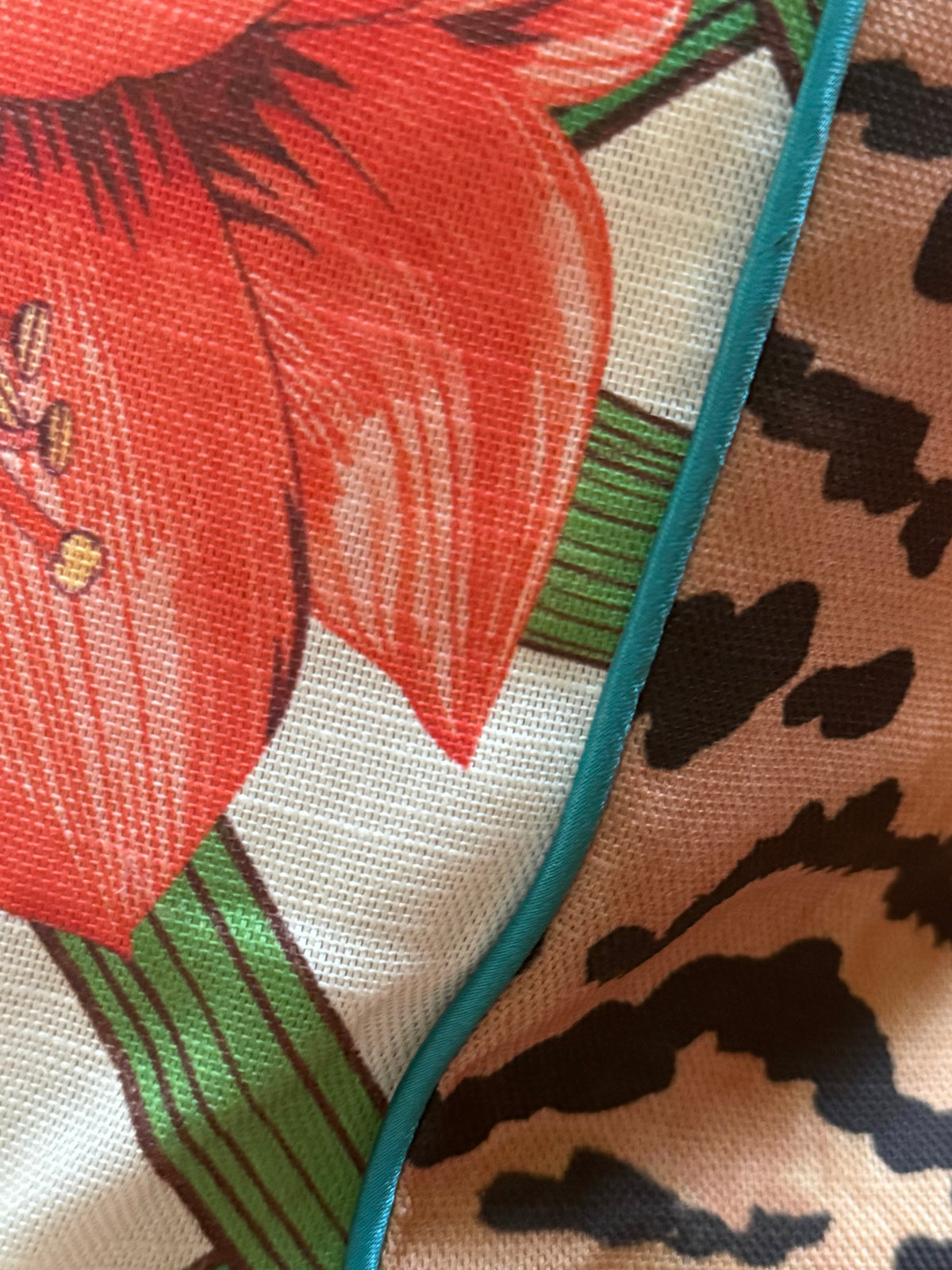 Close-up of the Estate Sale amaryllis print meeting the El Tigre back, joined by teal piping