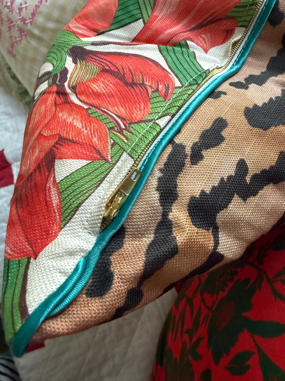 Close-up of the concealed zip and teal piping where the amaryllis print meets the tiger-stripe back