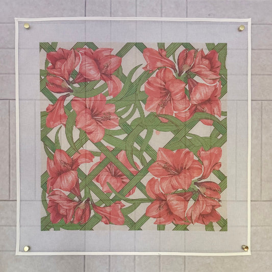 Full view of the 20-inch Estate Sale amaryllis trellis printed needlepoint canvas pinned flat, red blooms on a green lattice