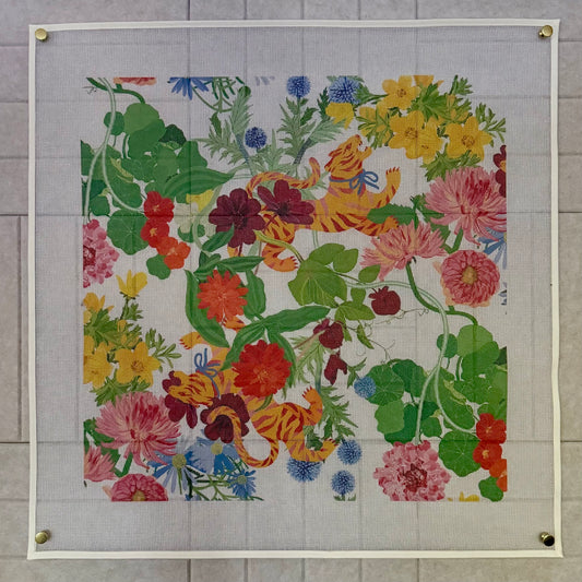 Full view of the 20-inch Jardín de Los Jefes printed needlepoint canvas pinned flat, tigers among botanicals with a blank canvas border