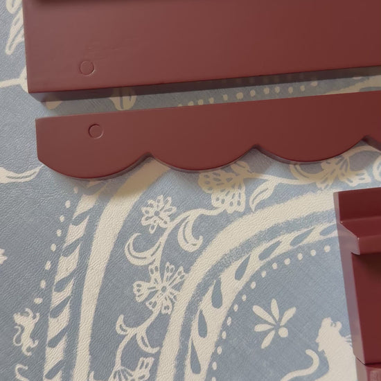 Video of oxblood wooden mahjong racks with scalloped pushers on blue and white fabric