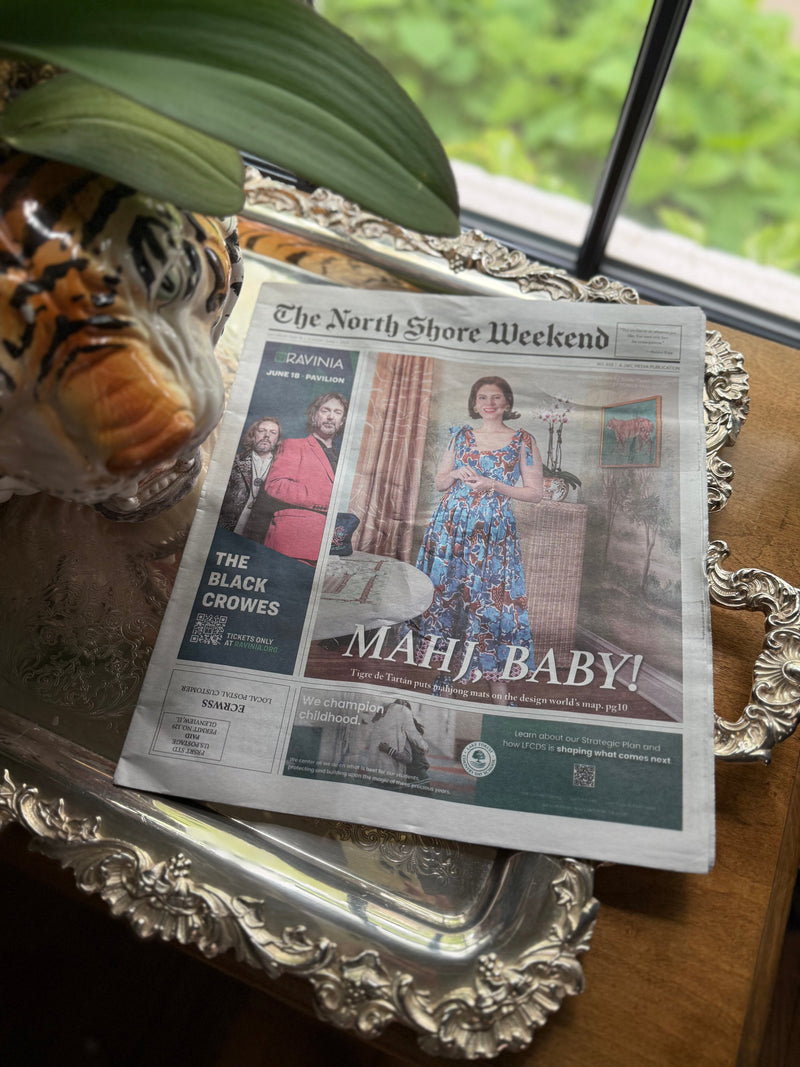The North Shore Weekend newspaper on a silver tray, open to the "MAHJ, BABY!" feature