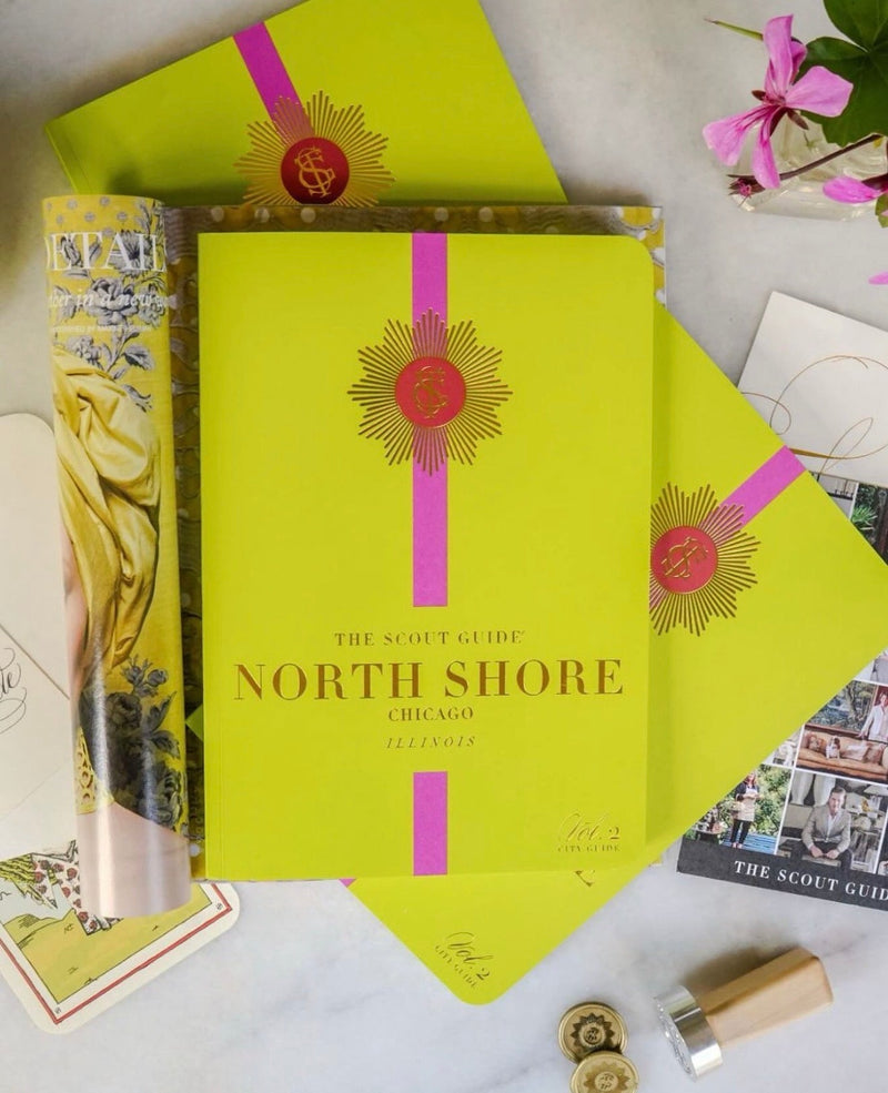 The Scout Guide North Shore Chicago edition in its chartreuse folder, with Tigre de Tartán pieces alongside